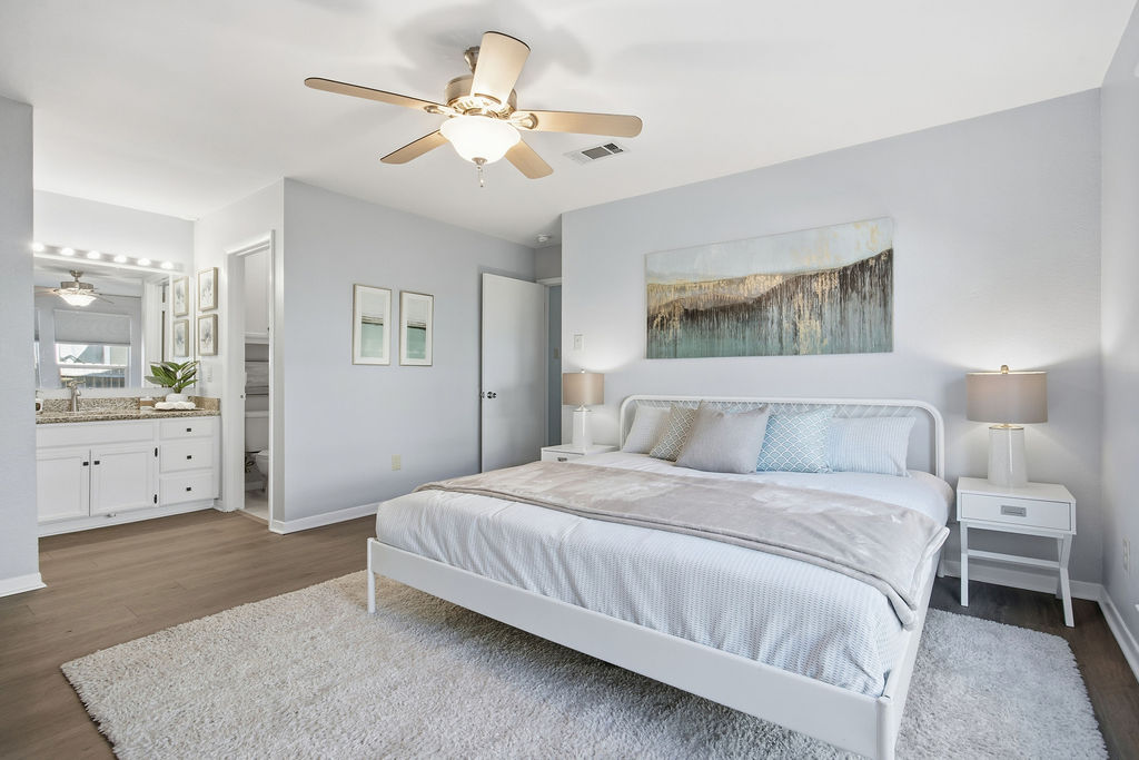 6486 Hart Lane Austin, TX 78731 - Photo 13 of 28 Bedroom with dark wood-style floors, a ceiling fan, and ensuite bathroom
