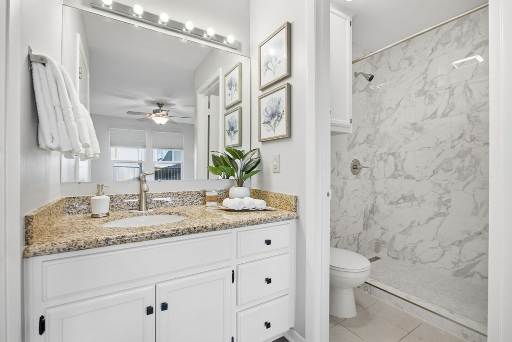 6486 Hart Lane Austin, TX 78731 - Photo 14 of 28 Full bathroom featuring vanity, a marble finish shower, and a ceiling fan