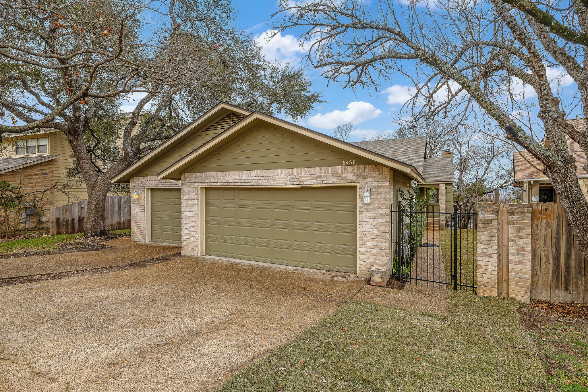 6486 Hart Lane Austin, TX 78731 - Photo 25 of 28 Garage featuring concrete driveway and a gate