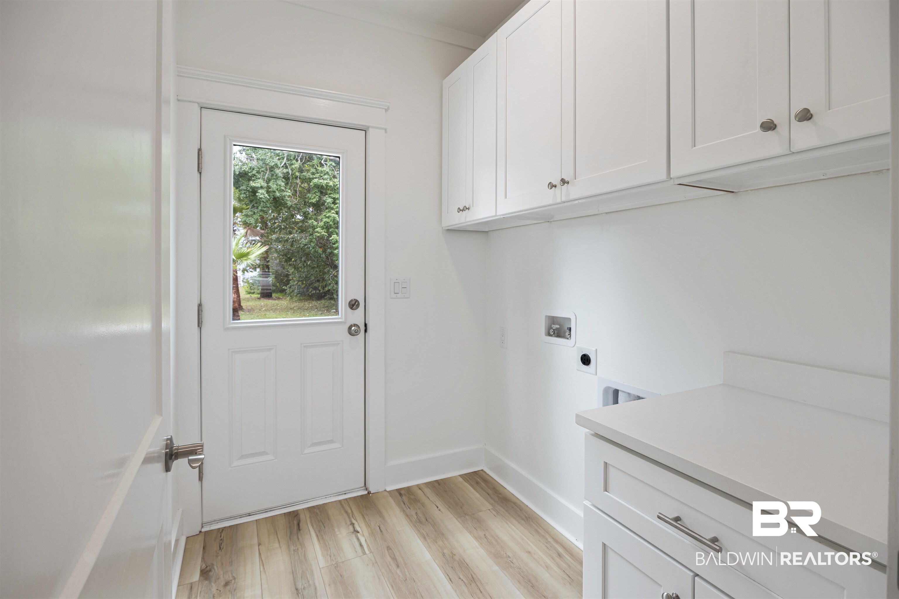 27591 Canal Road Orange Beach, AL 36561 - Photo 16 of 51 Laundry room featuring hookup for a washing machine, cabinet space, light wood finished floors, and hookup for an electric dryer