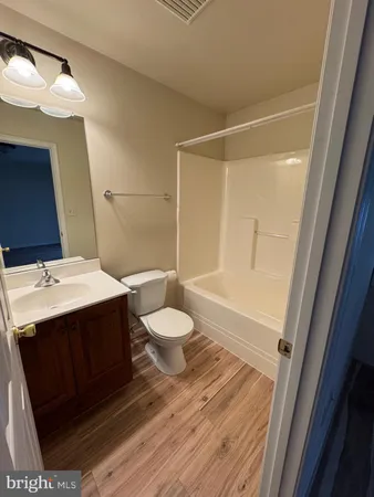 a view of a room with wooden floor