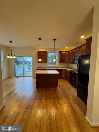 a view of a kitchen with a sink and cabinet with wooden floor
