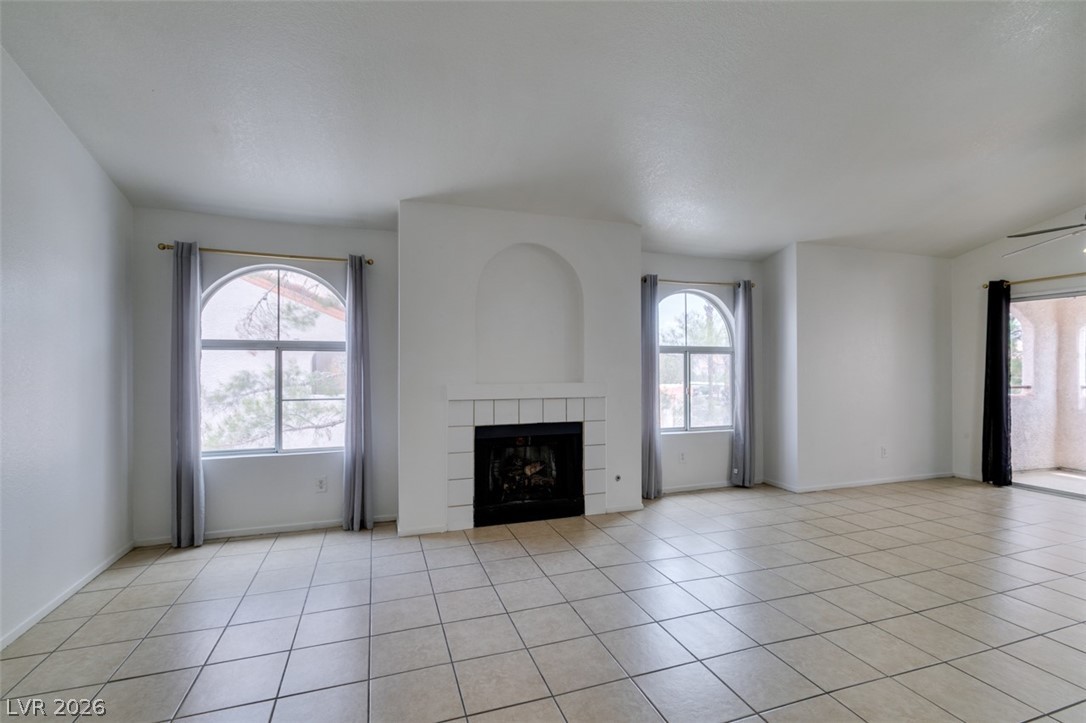 7570 West Flamingo Road, Unit 252 Las Vegas, NV 89147 - Photo 6 of 44 A graceful fireplace, arched windows, and tiled floors complete this inviting living area.