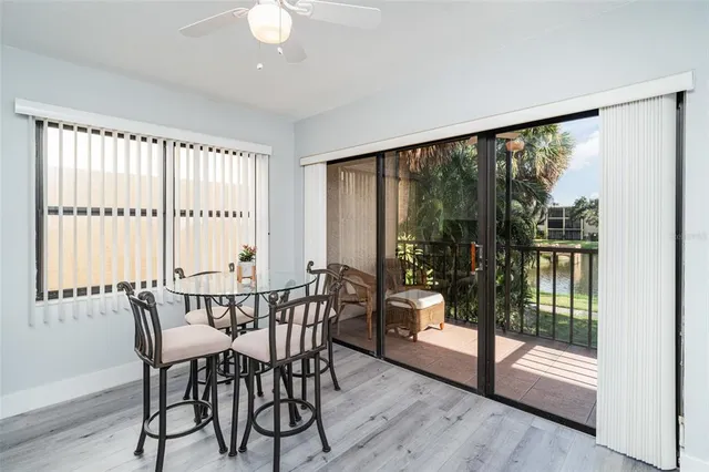 a view of a room with a large window and wooden floor