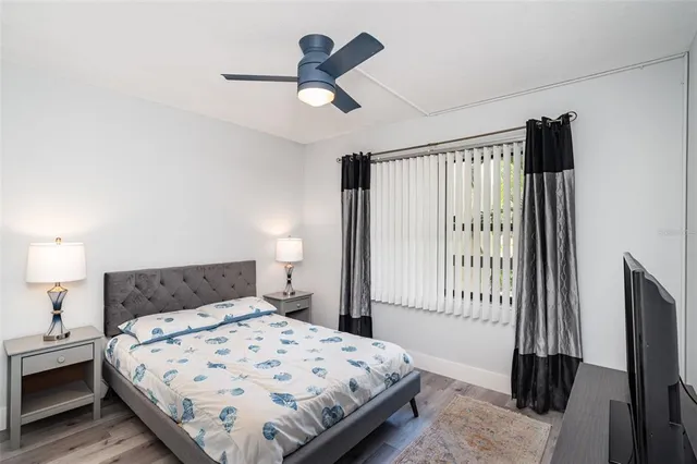 a bedroom with a large bed and a chandelier