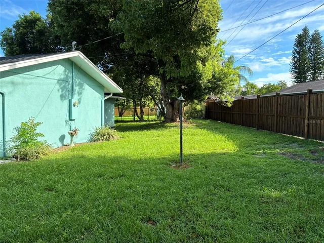 a view of a house with a backyard