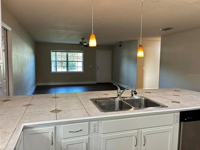 a kitchen that has a sink and a stove