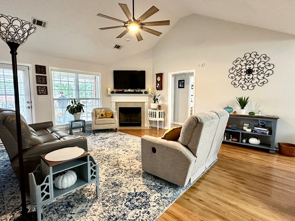 8013 Silverado Drive Columbus, GA 31909 - Photo 15 of 47 a living room with furniture a fireplace and a flat screen tv