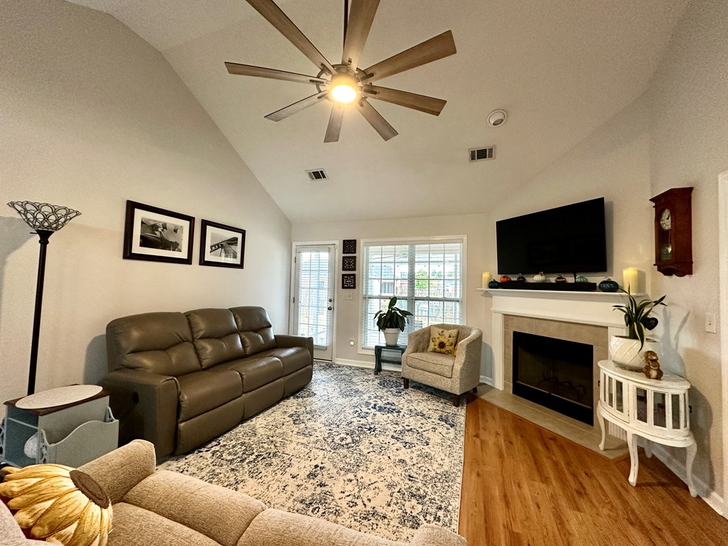 8013 Silverado Drive Columbus, GA 31909 - Photo 20 of 47 a living room with furniture a flat screen tv and a fireplace