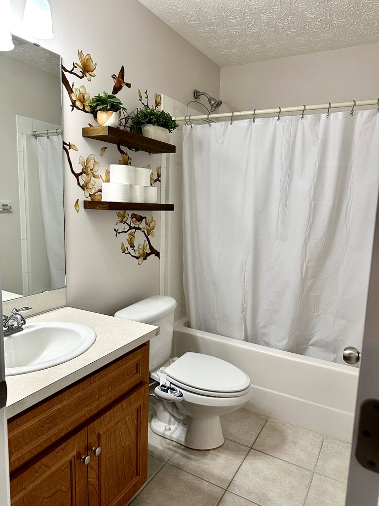 8013 Silverado Drive Columbus, GA 31909 - Photo 22 of 47 a bathroom with a sink a toilet and shower curtain