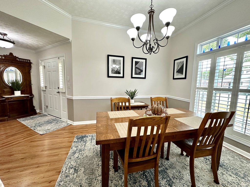 8013 Silverado Drive Columbus, GA 31909 - Photo 7 of 47 a view of a dining room with furniture a chandelier and wooden floor