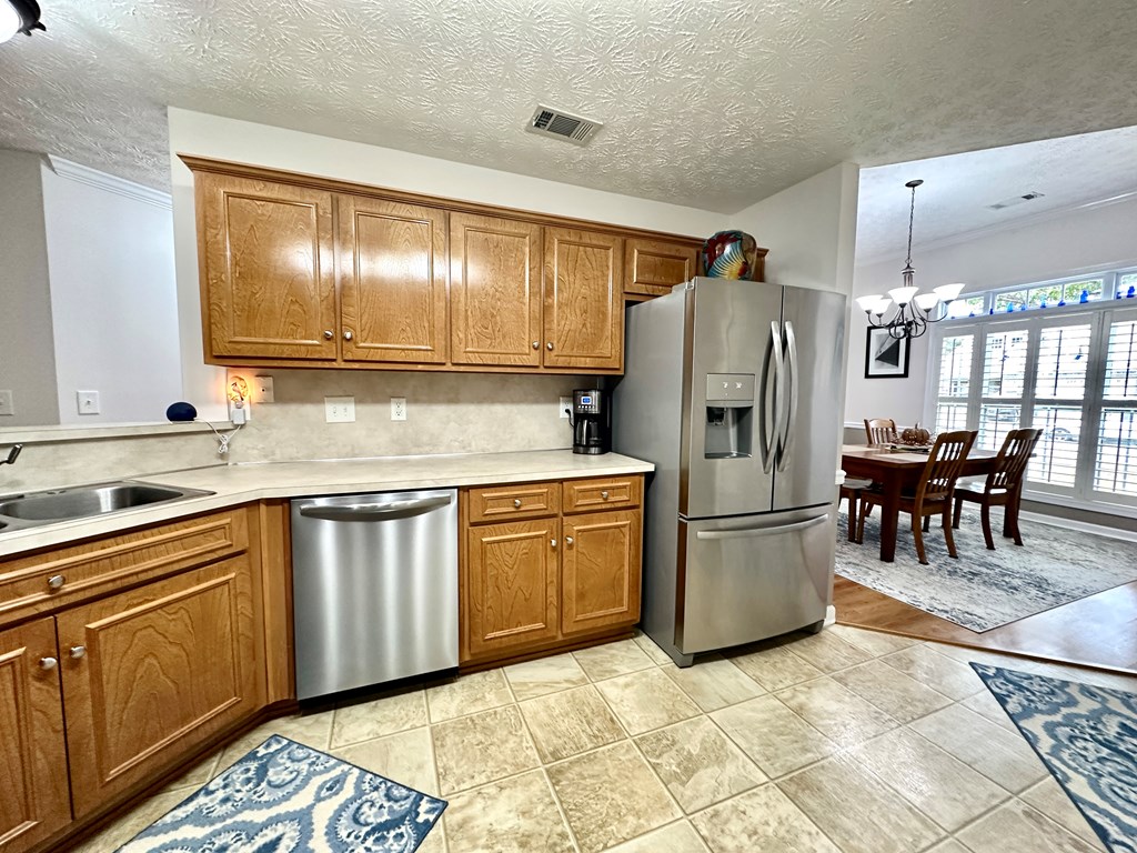 8013 Silverado Drive Columbus, GA 31909 - Photo 8 of 47 a kitchen with cabinets and refrigerator