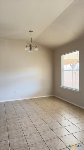 an empty room with windows and ceiling fan