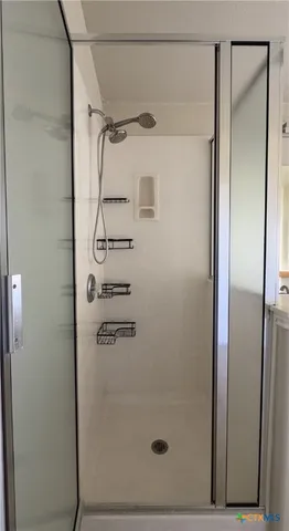 a bathroom with a glass shower door