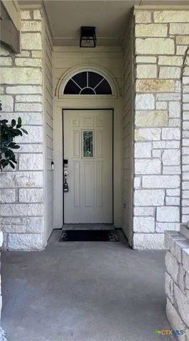 a view of entryway with brick walls