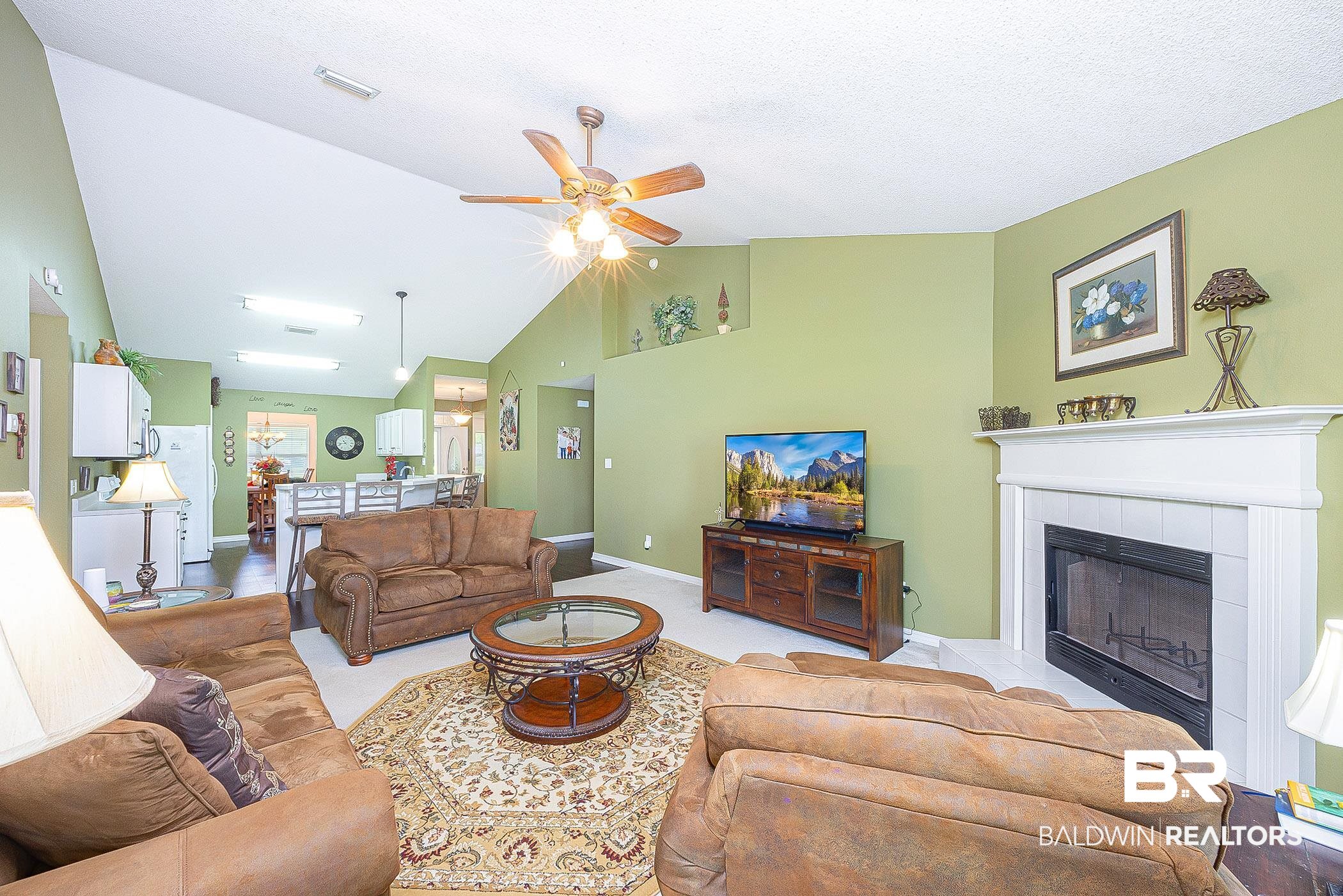 16154 Parke Boulevard Foley, AL 36535 - Photo 8 of 44 Spacious Living room featuring vaulted ceiling, fireplace and ceiling fan