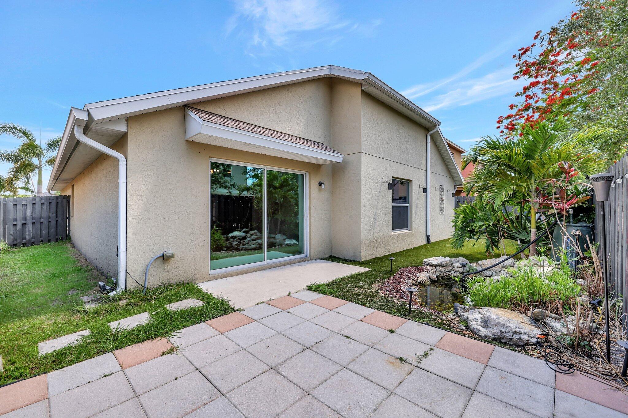 9331 Breakers Row Fort Pierce, FL 34945 - Photo 29 of 39 a front view of a house with garden