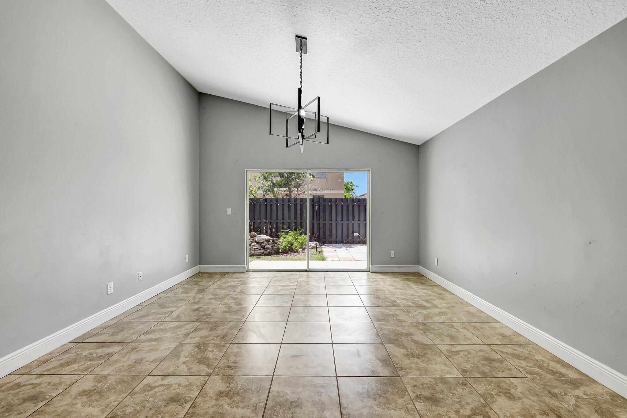 9331 Breakers Row Fort Pierce, FL 34945 - Photo 9 of 39 a view of a kitchen with a sink and chandelier fan