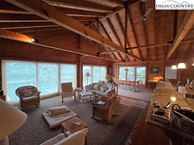 a living room with furniture floor to ceiling windows and floor to ceiling window