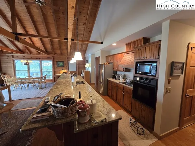 a kitchen with stainless steel appliances granite countertop a stove refrigerator and cabinets