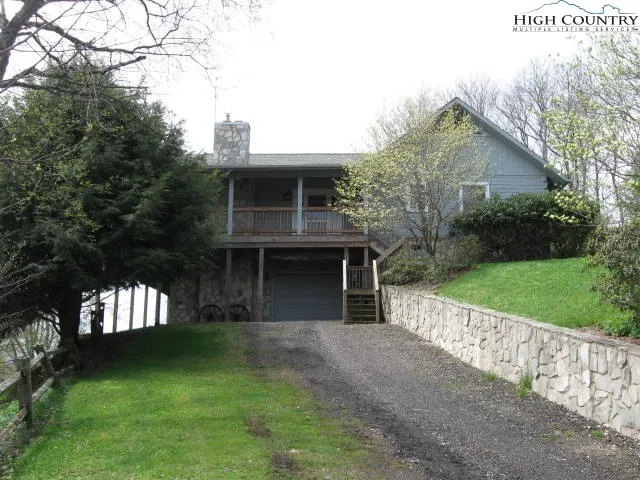 a front view of a house with a yard and green space