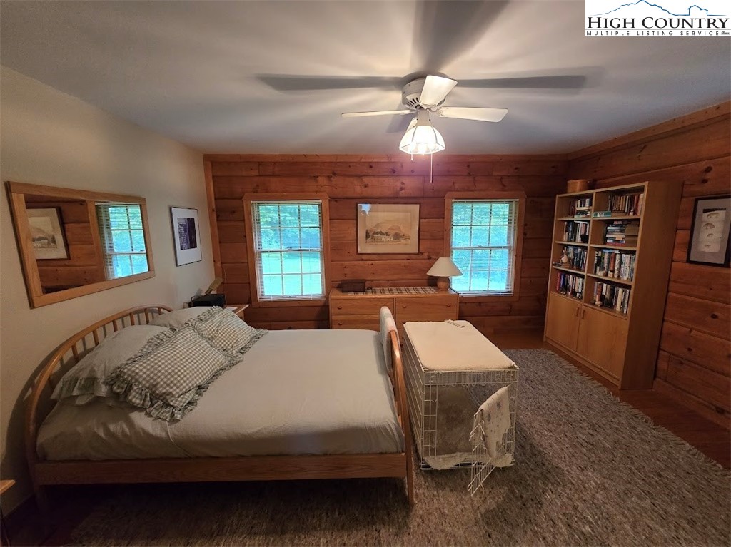 979 Wagon Road Warrensville, NC 28693 - Photo 22 of 50 a bedroom with a bed and a chandelier