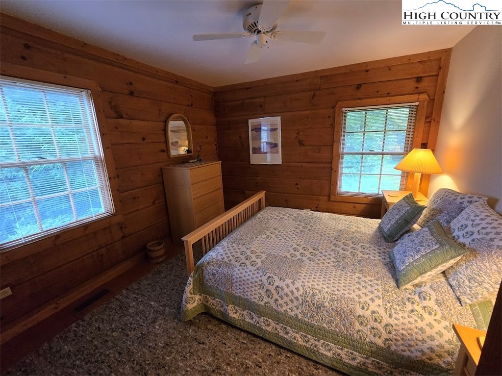 979 Wagon Road Warrensville, NC 28693 - Photo 27 of 50 a bedroom with a bed and a window