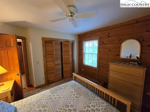a view of a bedroom with furniture and window