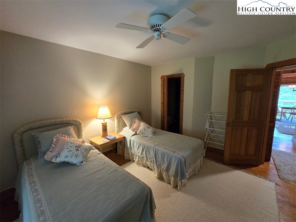 979 Wagon Road Warrensville, NC 28693 - Photo 29 of 50 a bedroom with two beds and a chandelier