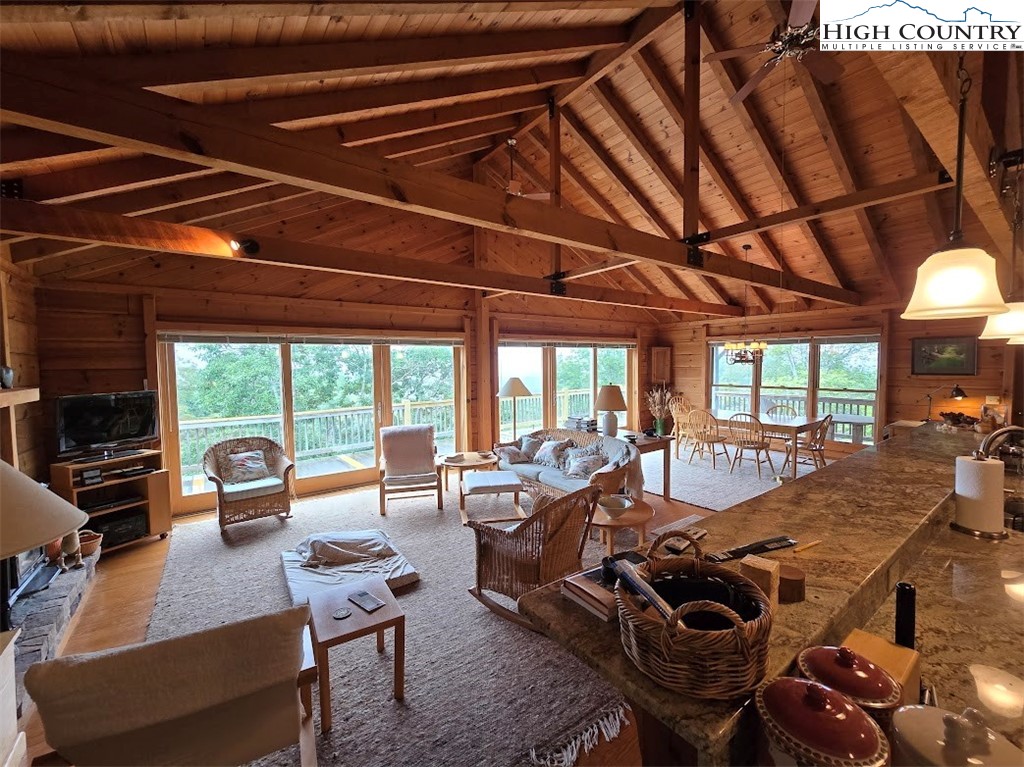 979 Wagon Road Warrensville, NC 28693 - Photo 30 of 50 a living room with furniture a table and chairs next to a window