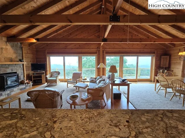a living room with furniture a fireplace and wooden floor