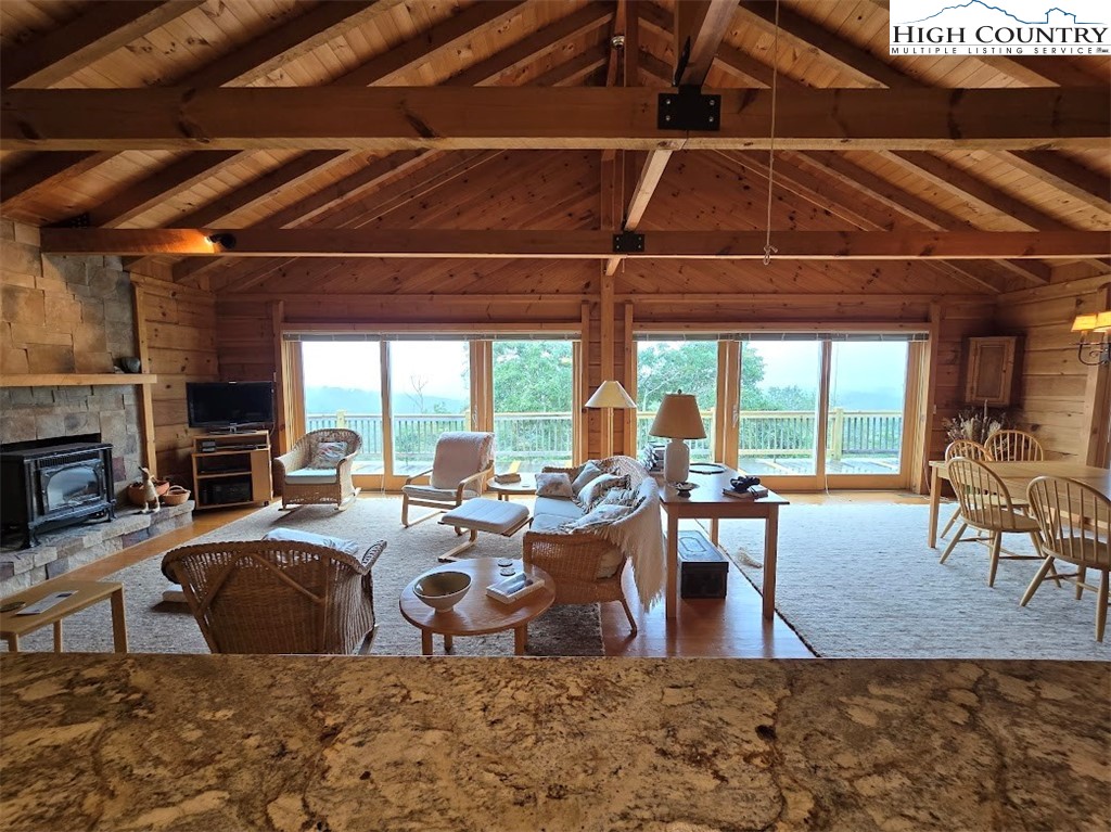 979 Wagon Road Warrensville, NC 28693 - Photo 31 of 50 a living room with furniture a fireplace and wooden floor
