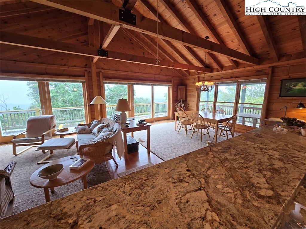 979 Wagon Road Warrensville, NC 28693 - Photo 34 of 50 a living room with furniture a wooden floor and a large window