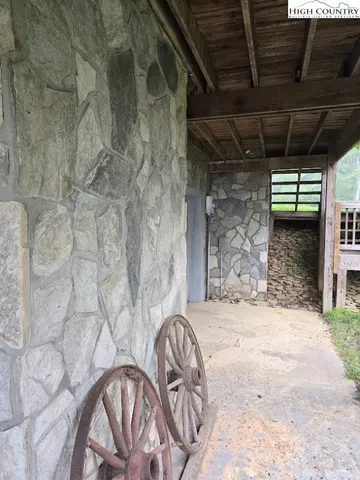 a view of porch with a table and chairs