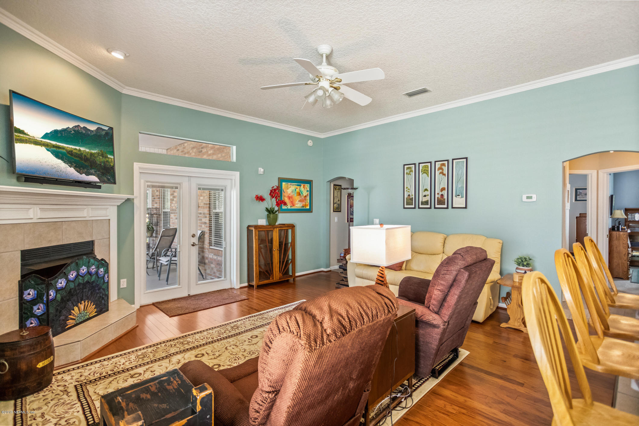 1764 Keswick Road St. Augustine, FL 32084 - Photo 5 of 20 a living room with furniture a flat screen tv and a fireplace