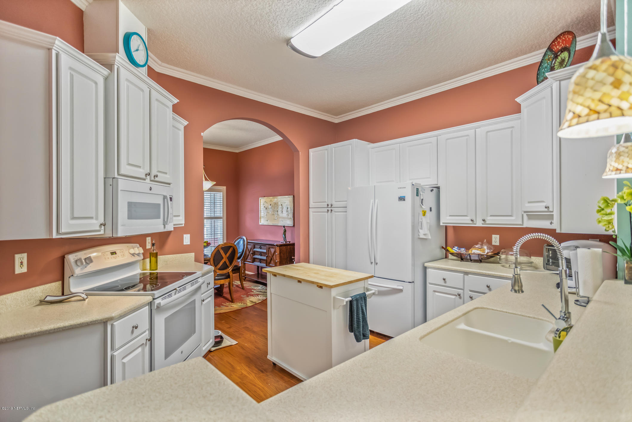 1764 Keswick Road St. Augustine, FL 32084 - Photo 8 of 20 a large white kitchen with a sink and a large window
