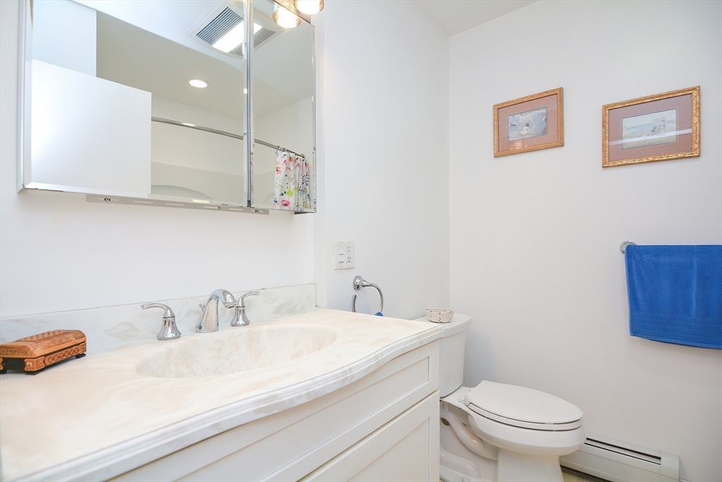 115 Highcrest Road Fall River, MA 02720 - Photo 12 of 38 a bathroom with a sink a toilet and a mirror