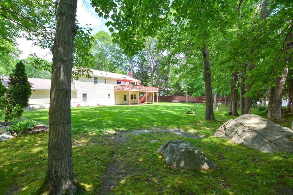 115 Highcrest Road Fall River, MA 02720 - Photo 32 of 38 a backyard of a house with large trees and plants
