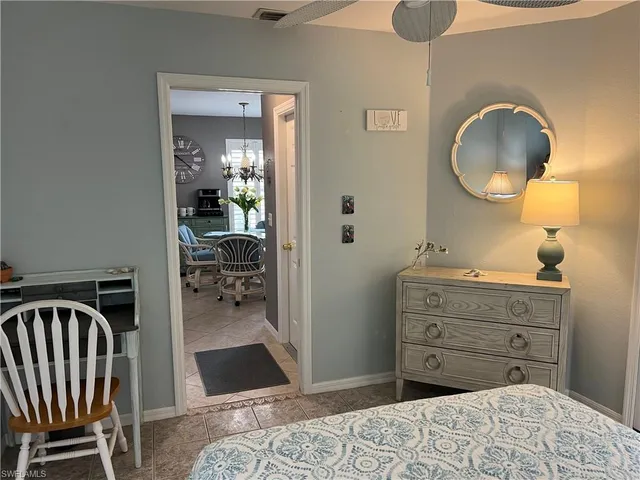 a bedroom with a bed and a mirror