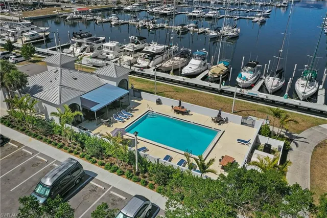 a front view of multi story residential apartment building with yard and sign board