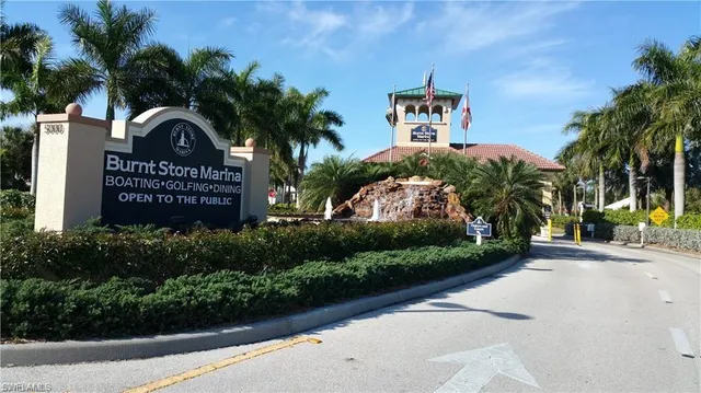 a front view of a house with a garden and trees