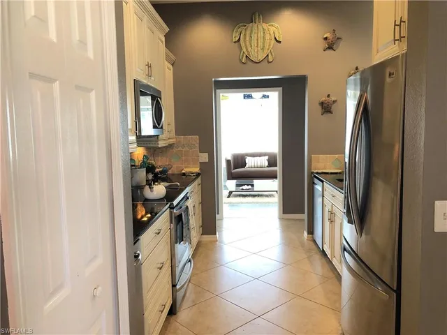 a kitchen with stainless steel appliances a refrigerator and a stove