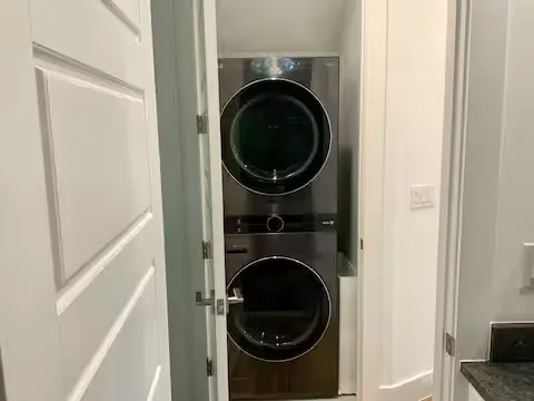 a view of a hallway with washer and dryer