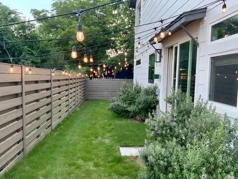 a view of a pathway of a house with a yard