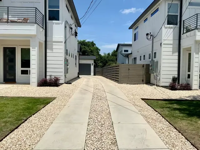 a view of a patio with a table and chairs next to a yard