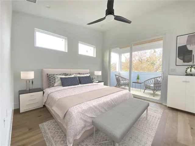 a bedroom with a large bed and a large window