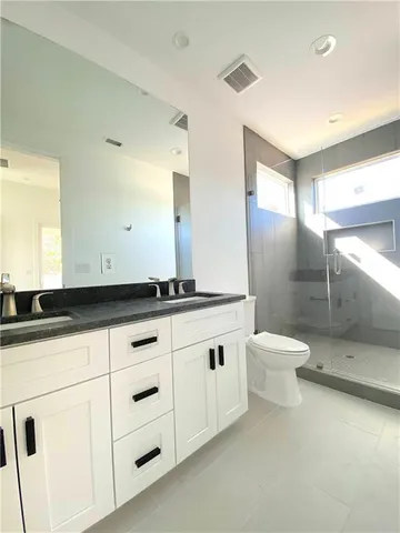 a bathroom with a sink a toilet and a mirror