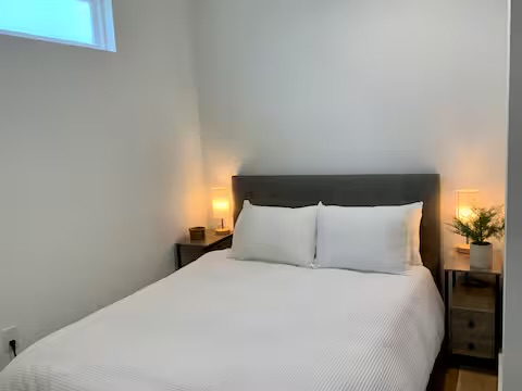 6100 Ponca Street, Unit 2 Austin, TX 78741 - Photo 9 of 17 a large bed sitting in a bedroom next to a lamp