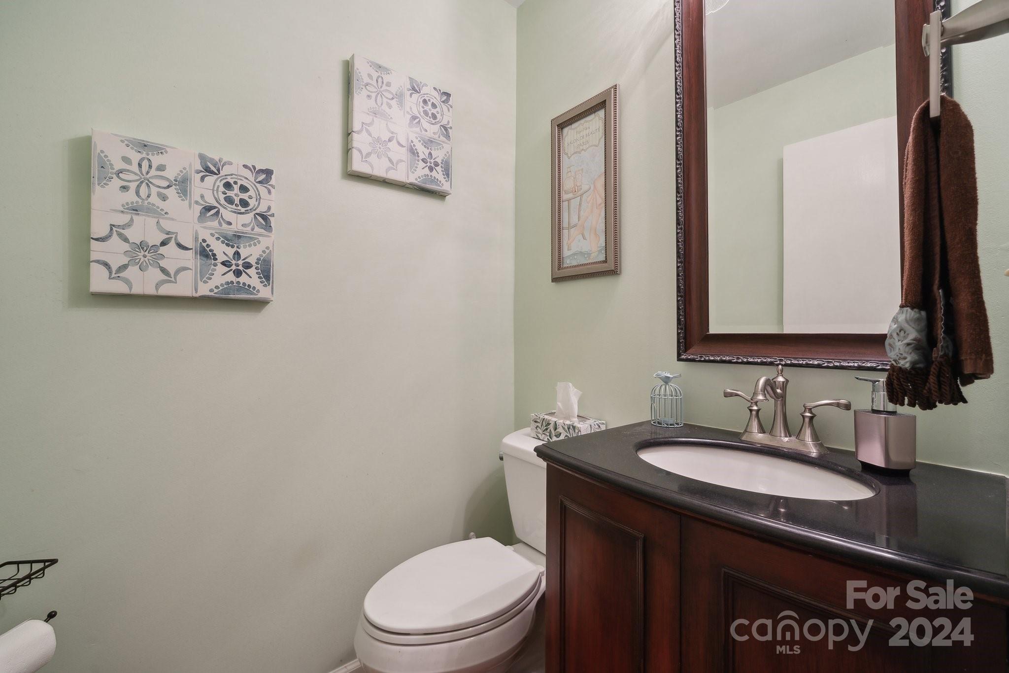 9012 St Thomas Lane Charlotte, NC 28277 - Photo 12 of 25 a bathroom with a granite countertop toilet sink and mirror