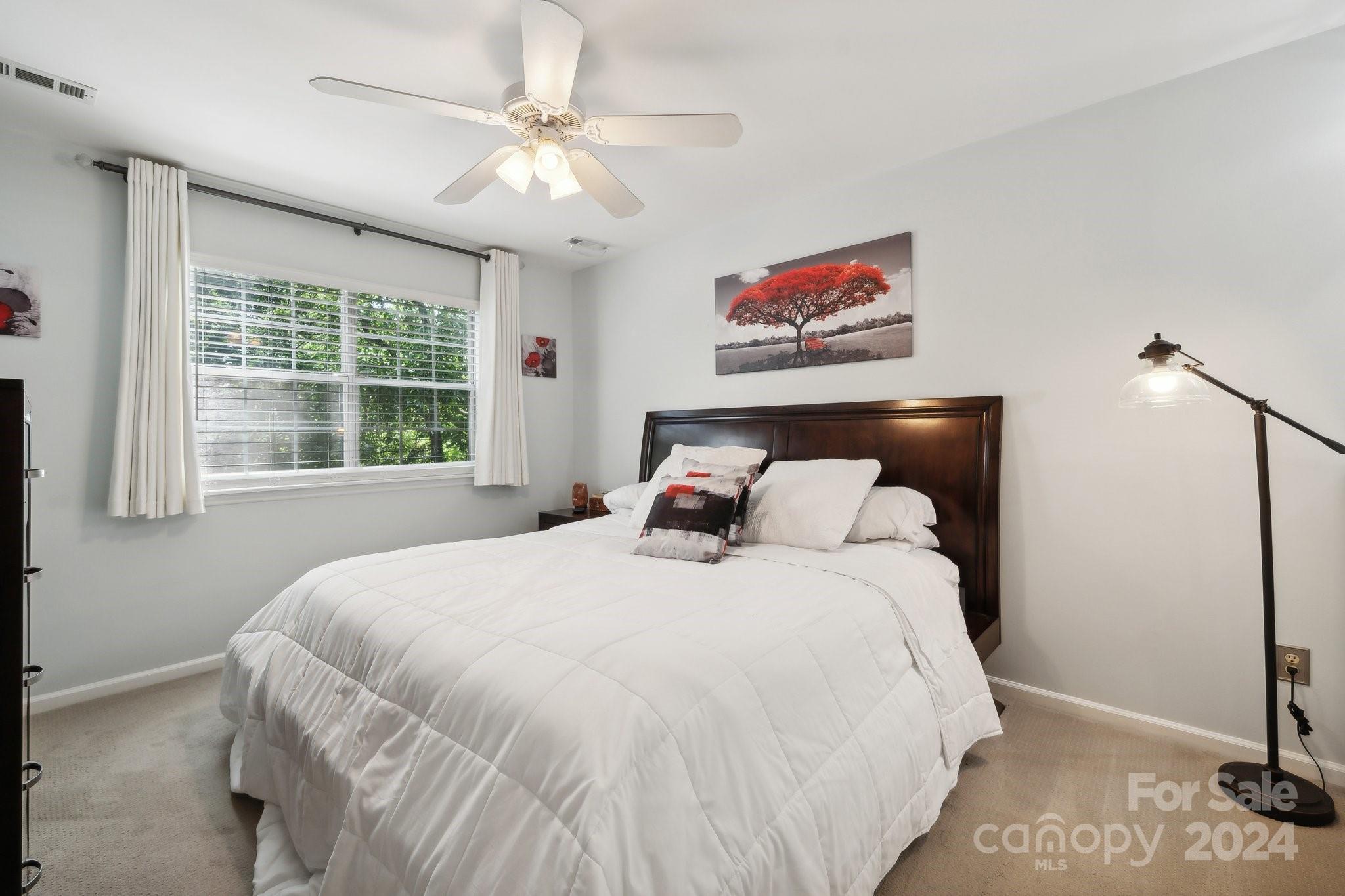 9012 St Thomas Lane Charlotte, NC 28277 - Photo 14 of 25 a large bed sitting in a bedroom next to a window